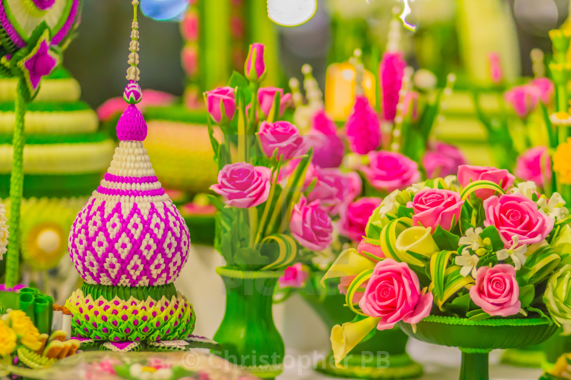 Colorful Thai traditional flower garland on green banana leaves